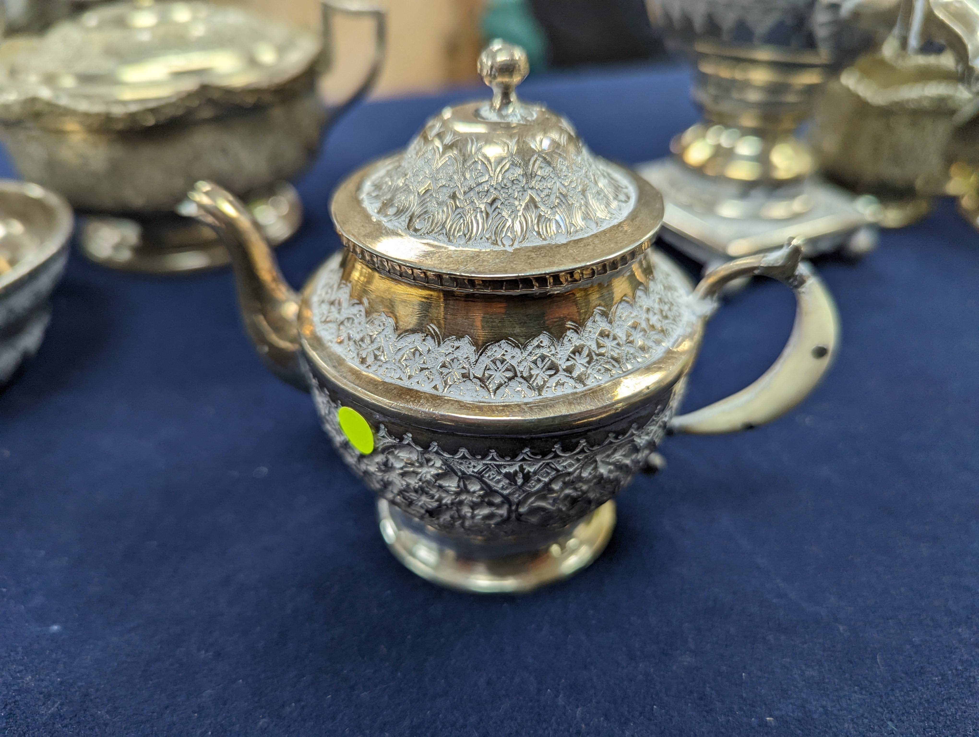 A set of six Persian embossed 84 standard white metal coffee cup holders and matching sugar bowl and cover by Vartan and four other Persian white metal items.